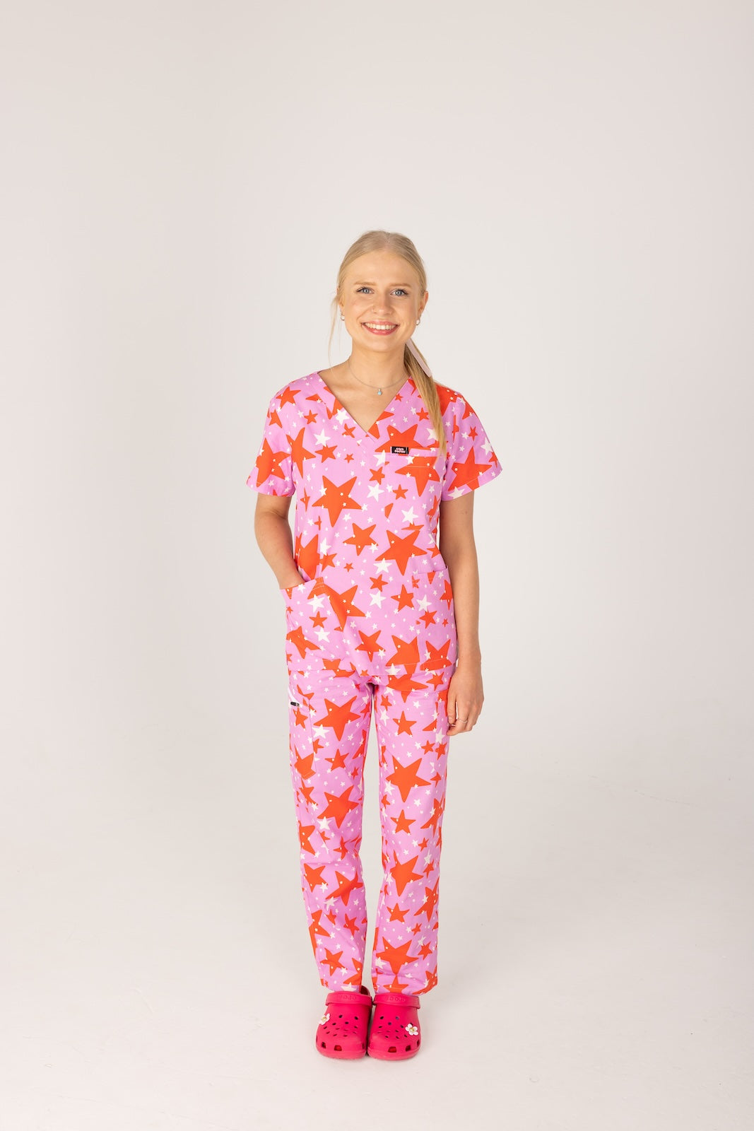 person wearing a purple and red star pair of fun scrubs