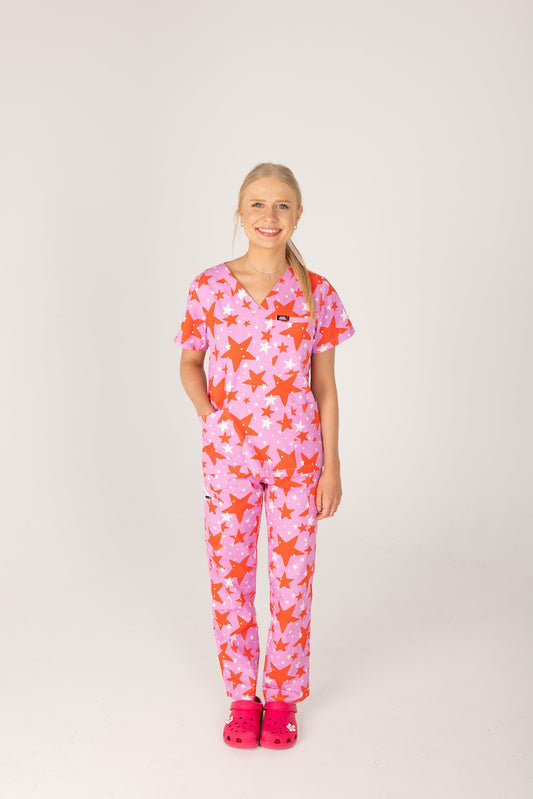 person wearing a purple and red star pair of fun scrubs