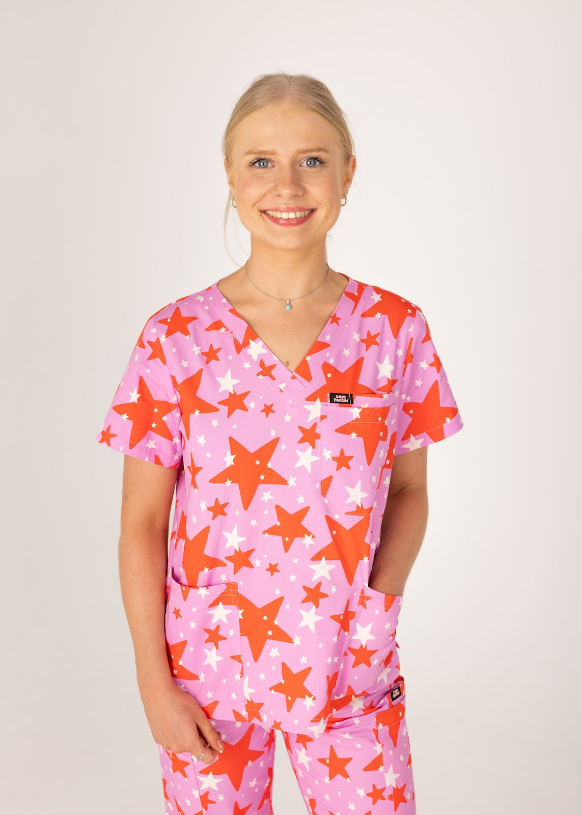 person wearing a purple and red star pair of fun scrubs