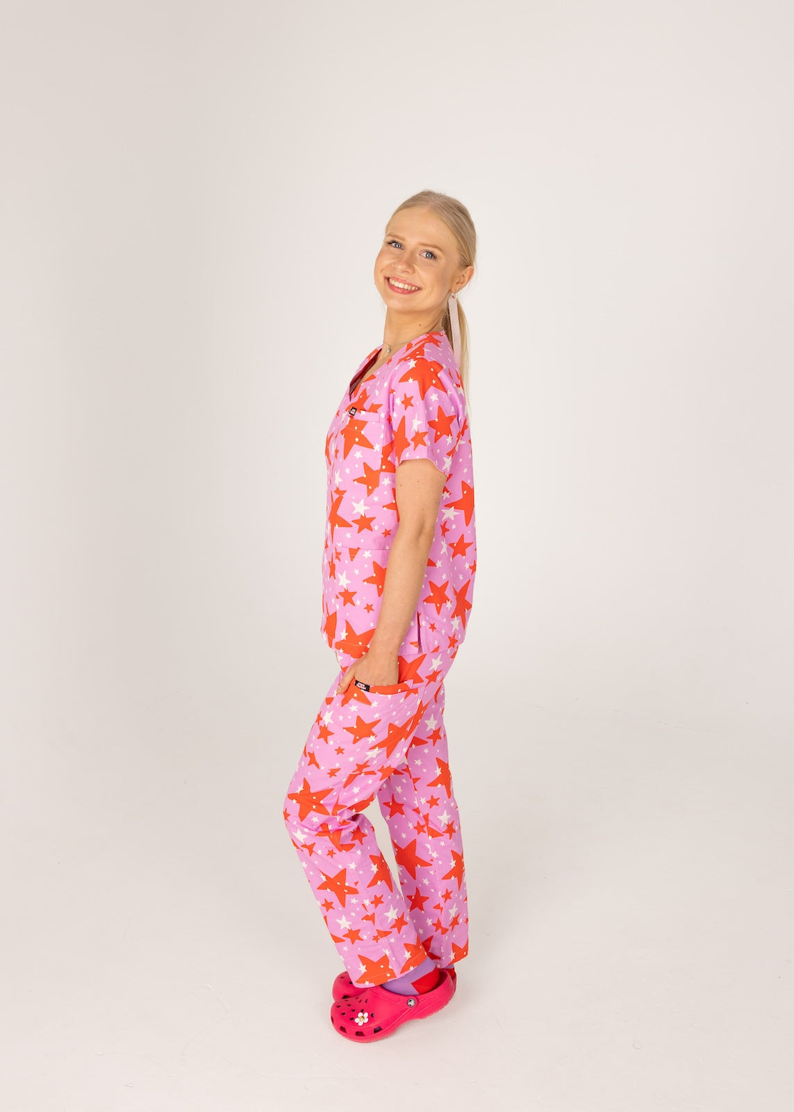 person wearing a purple and red star pair of fun scrubs