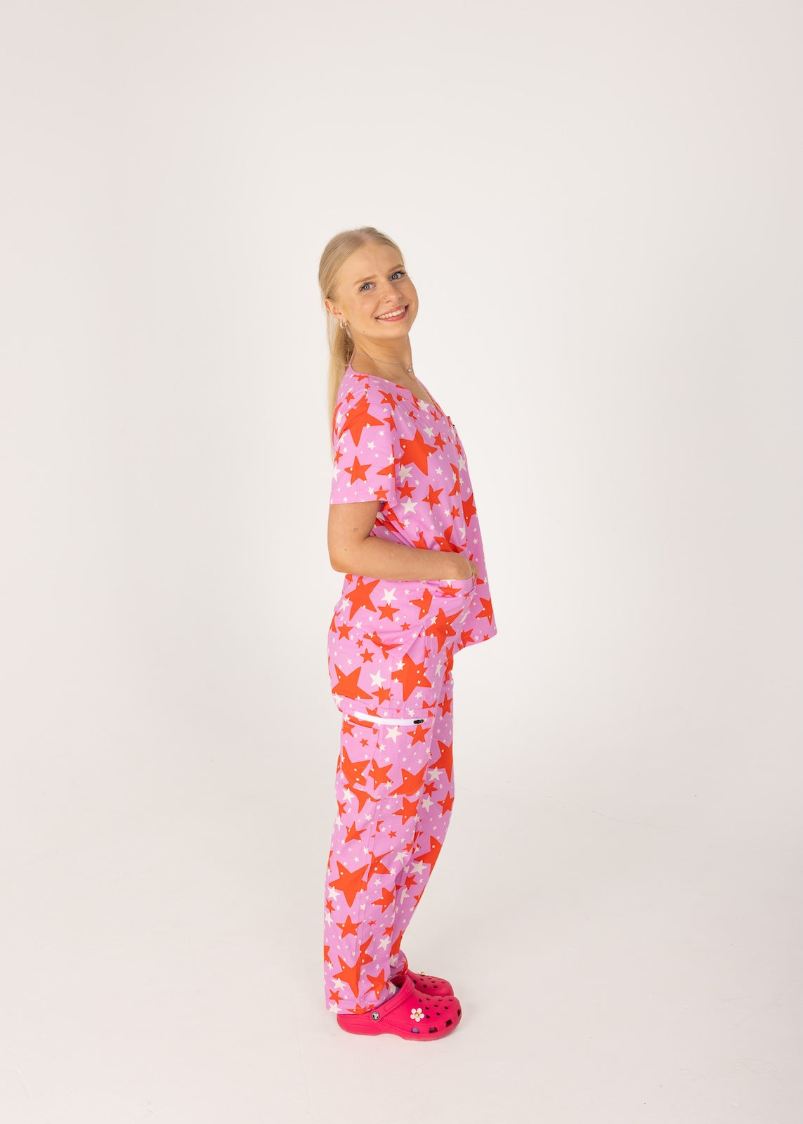 person wearing a purple and red star pair of fun scrubs