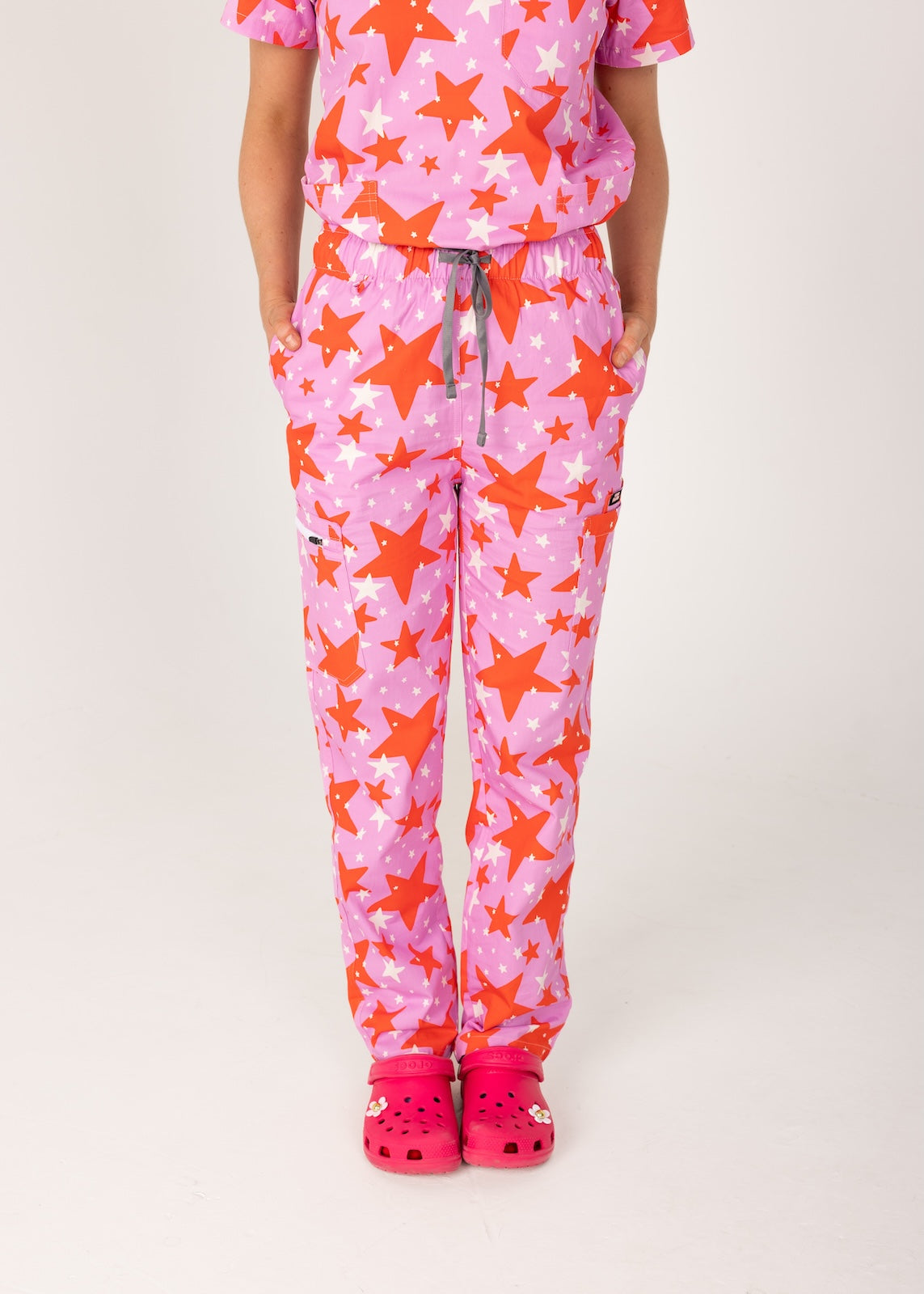 person wearing a purple and red star pair of fun scrubs