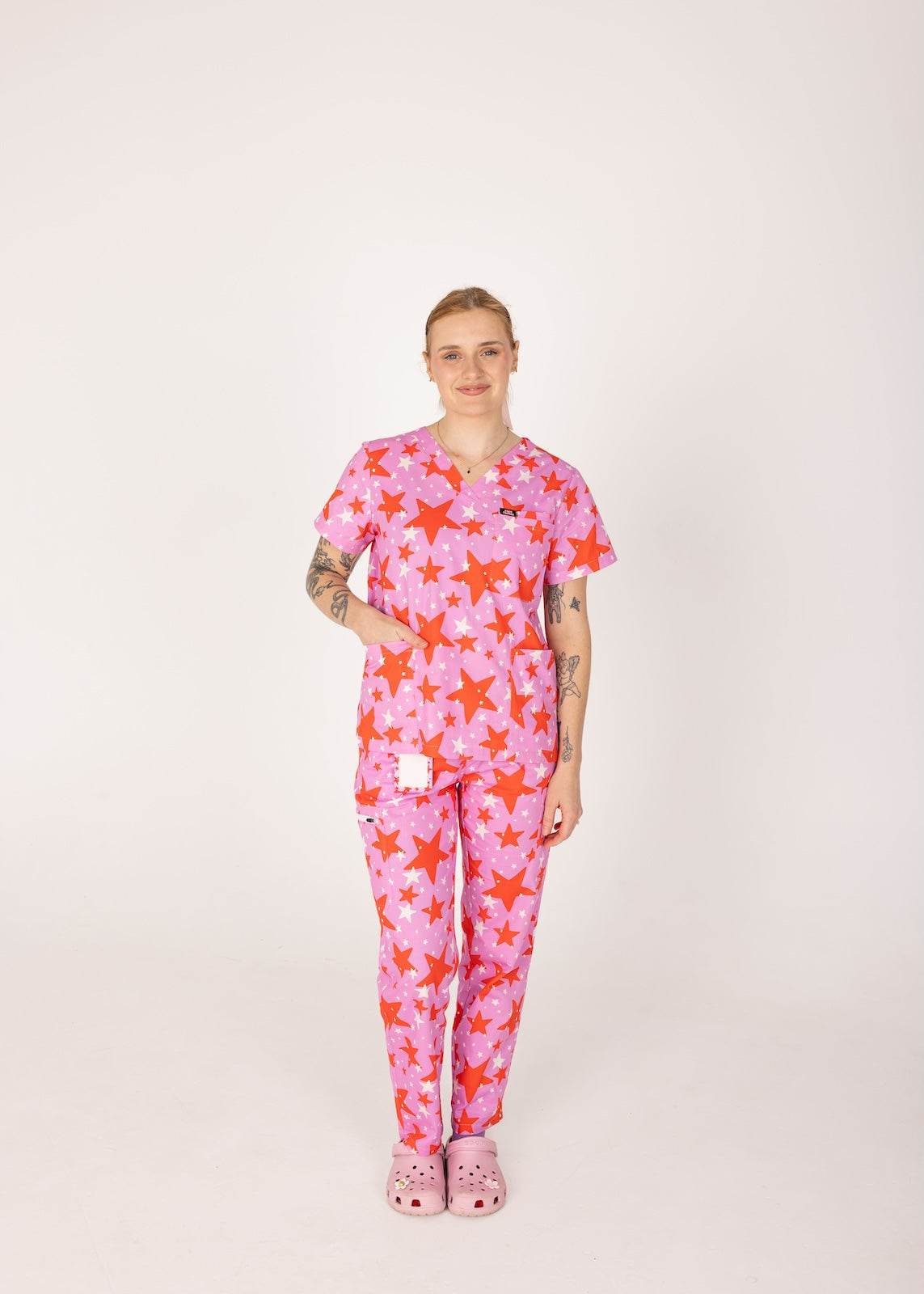 person wearing a purple and red star pair of fun scrubs