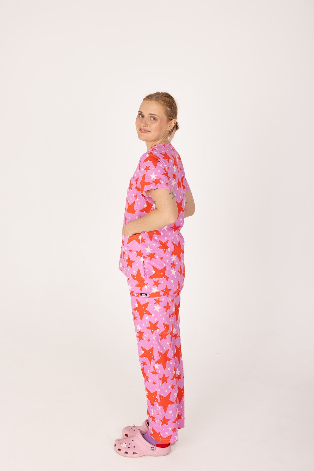 person wearing a purple and red star pair of fun scrubs