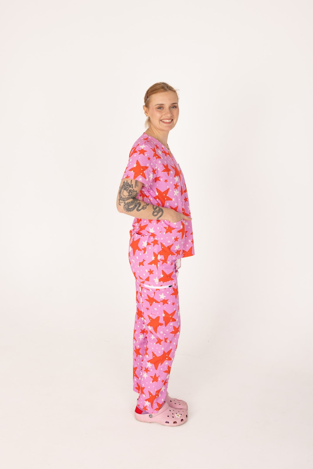 person wearing a purple and red star pair of fun scrubs