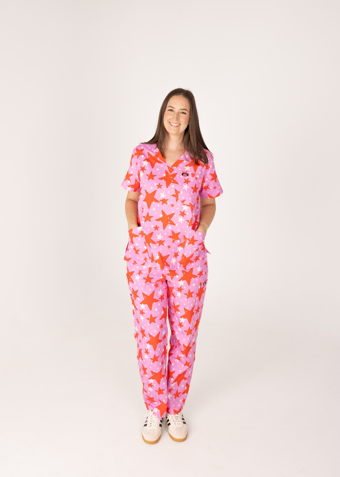 person wearing a purple and red star pair of fun scrubs