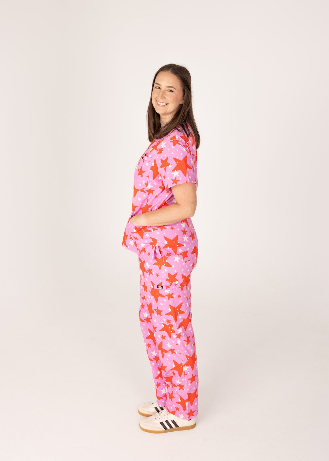 person wearing a purple and red star pair of fun scrubs