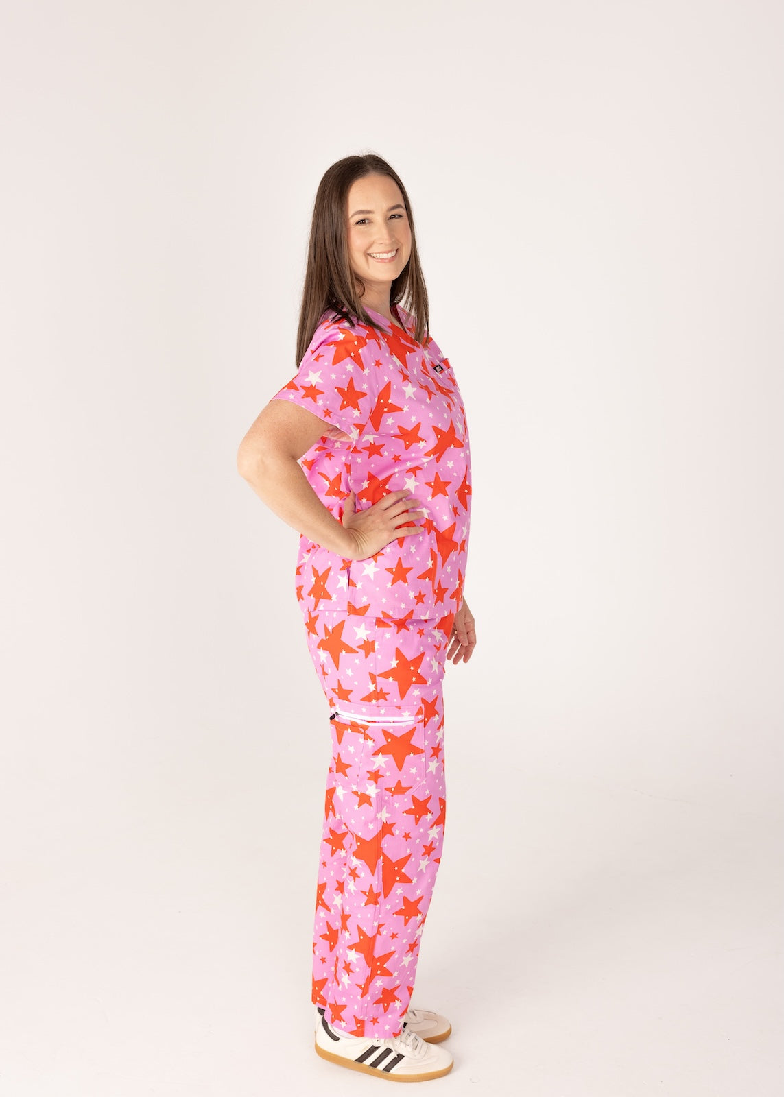 person wearing a purple and red star pair of fun scrubs