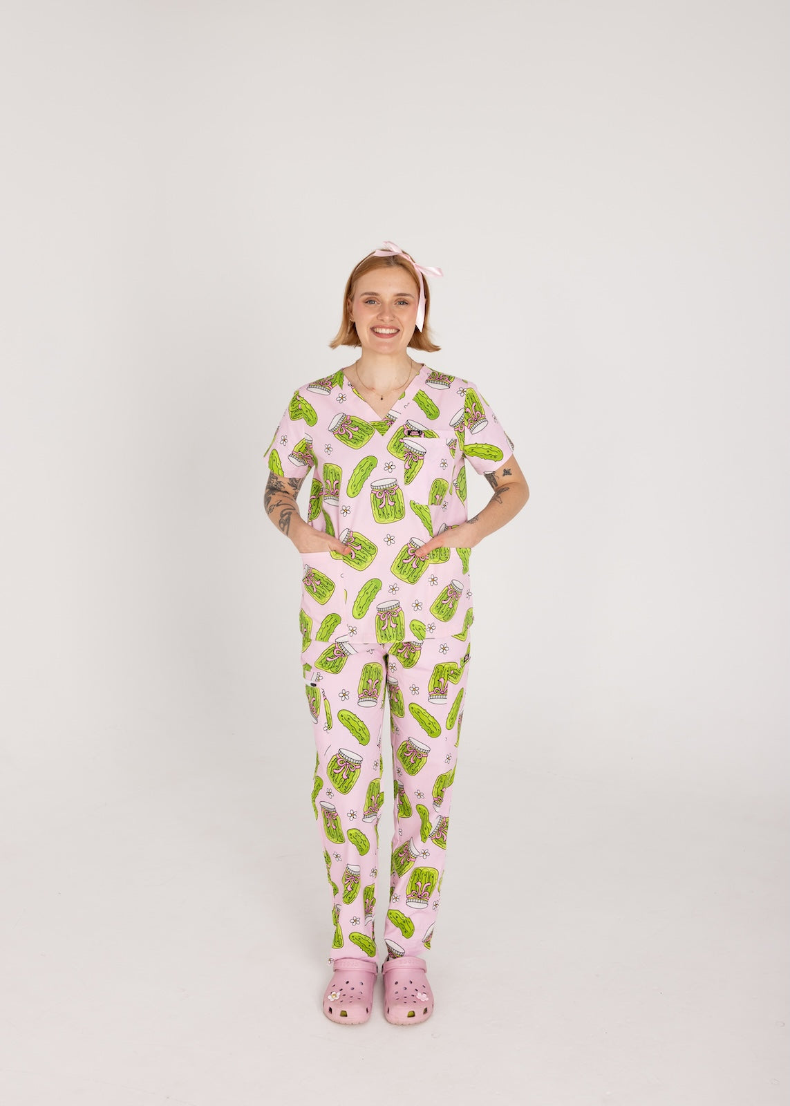 Person wearing pink fun scrubs with pickle pattern