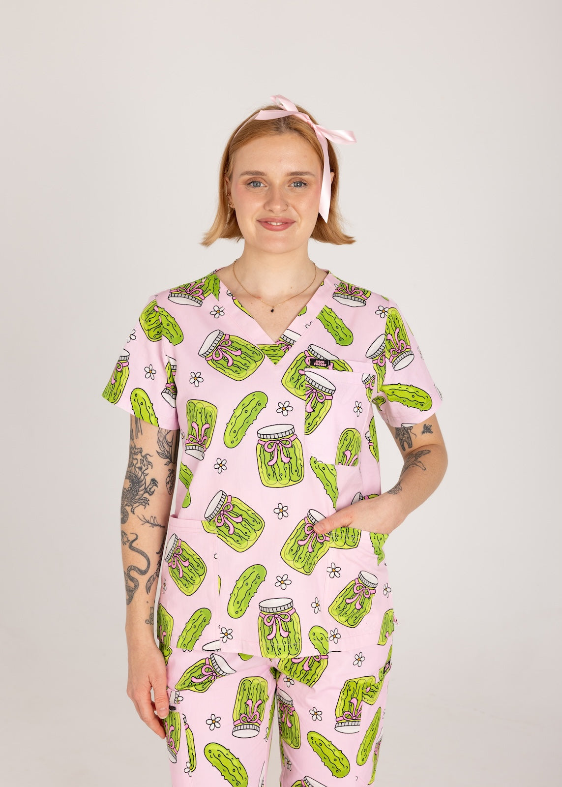 Person wearing pink fun scrubs with pickle pattern