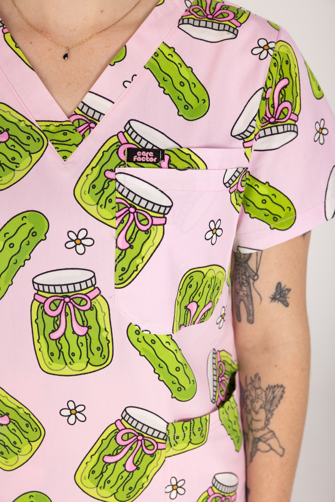 Person wearing pink fun scrubs with pickle pattern