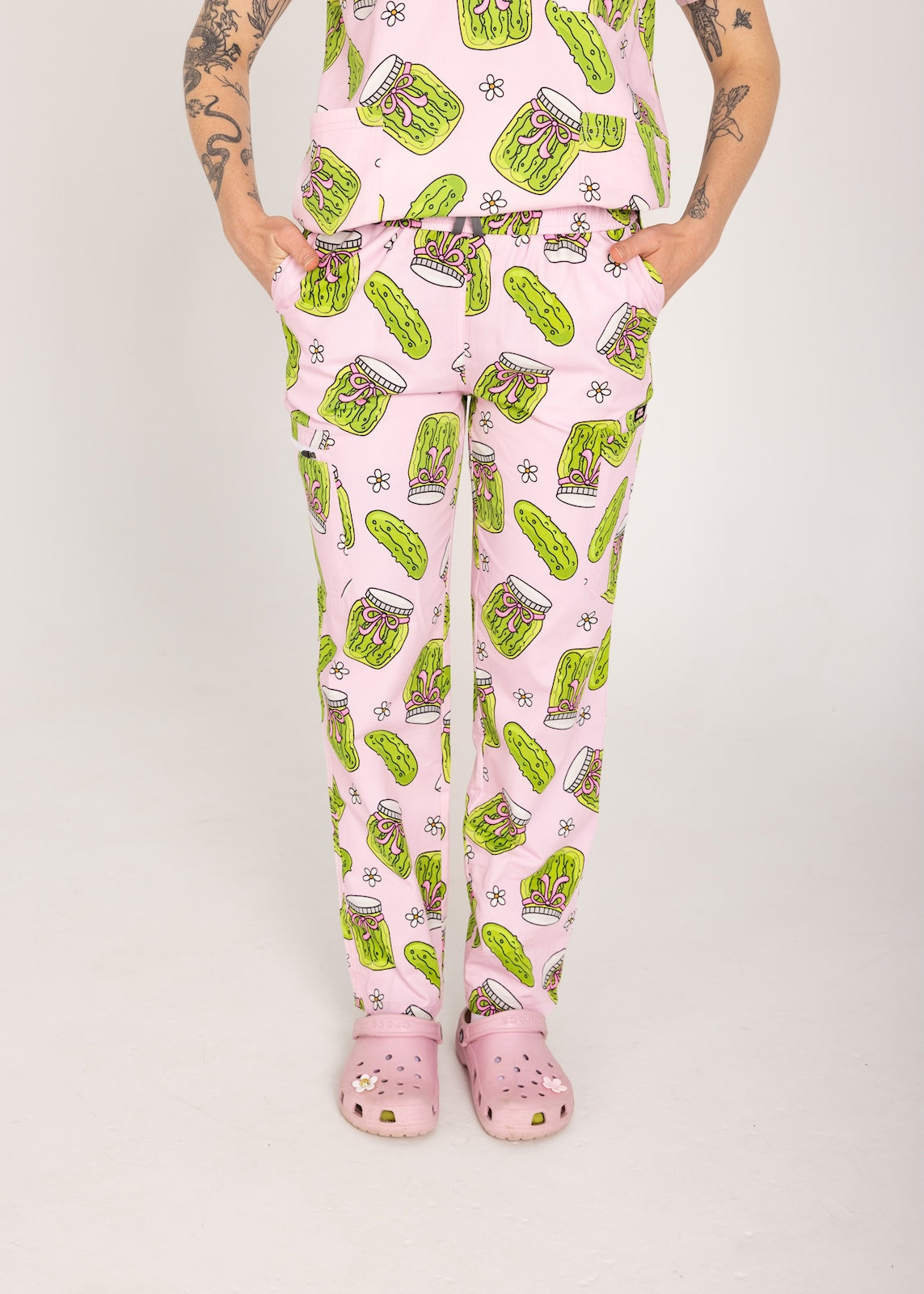 Person wearing pink fun scrubs with pickle pattern