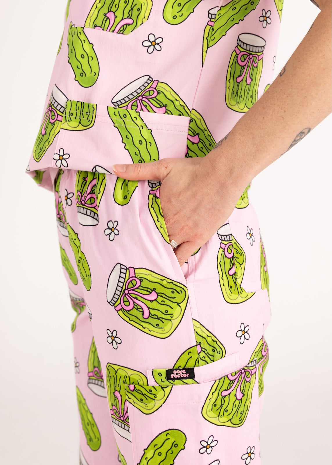 Person wearing pink fun scrubs with pickle pattern