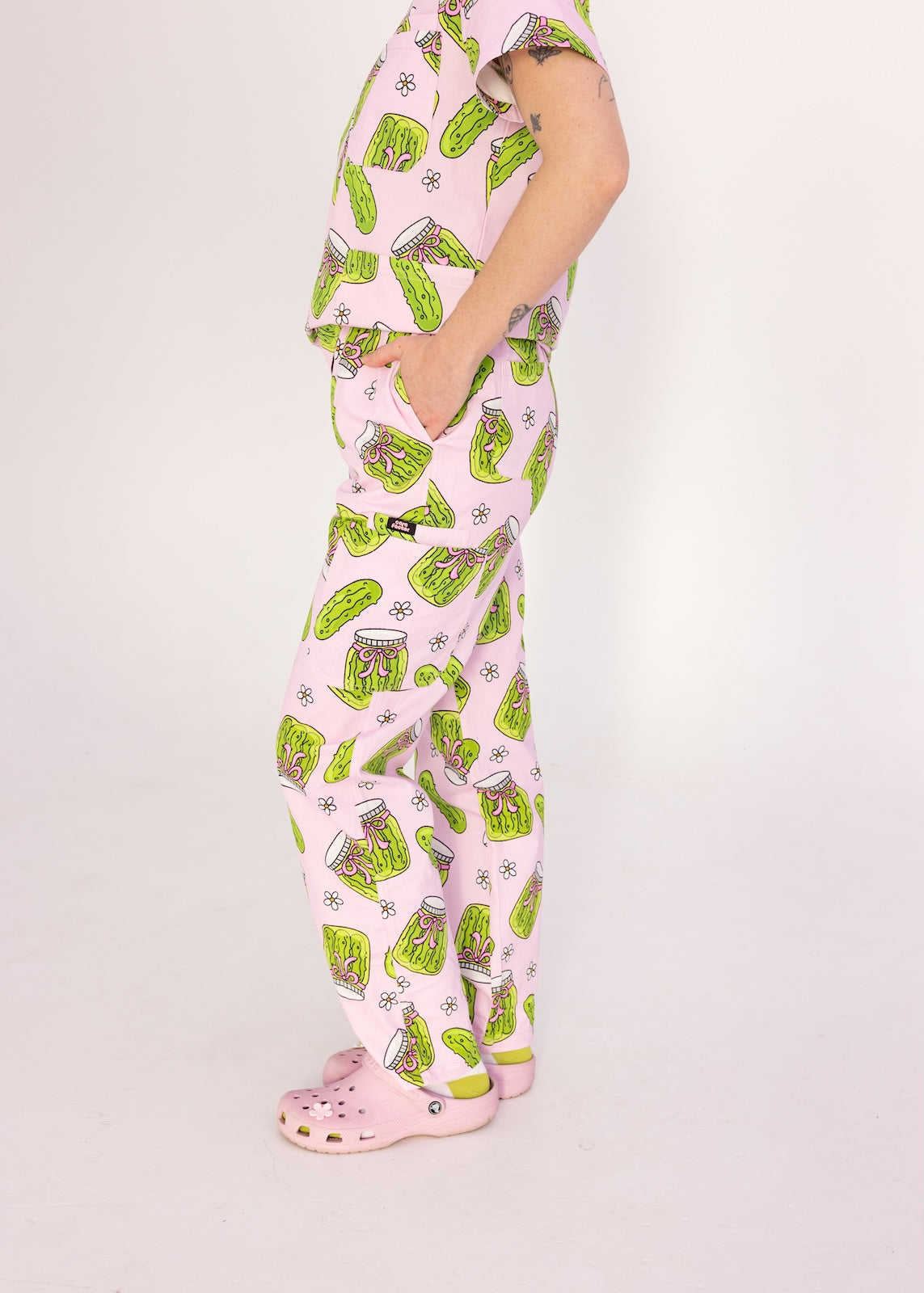 Person wearing pink fun scrubs with pickle pattern