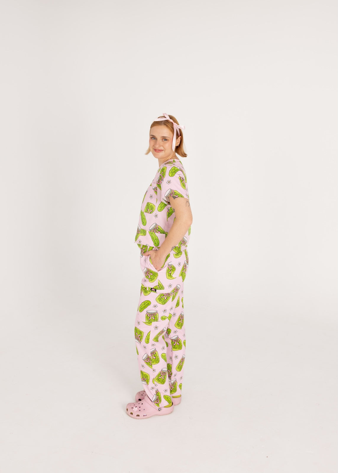 Person wearing pink fun scrubs with pickle pattern