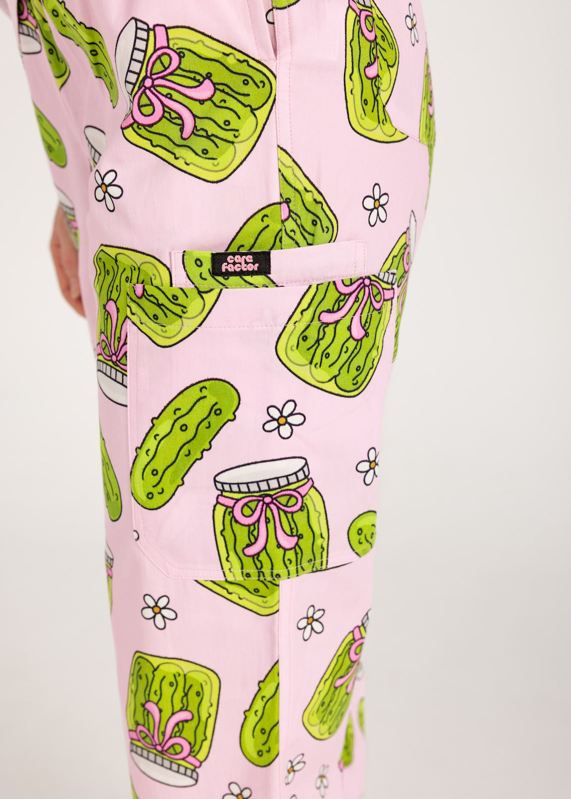 Person wearing pink fun scrubs with pickle pattern