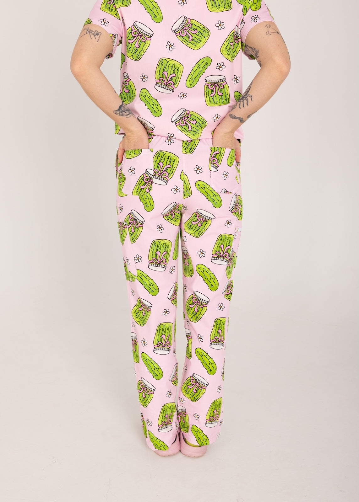 Person wearing pink fun scrubs with pickle pattern