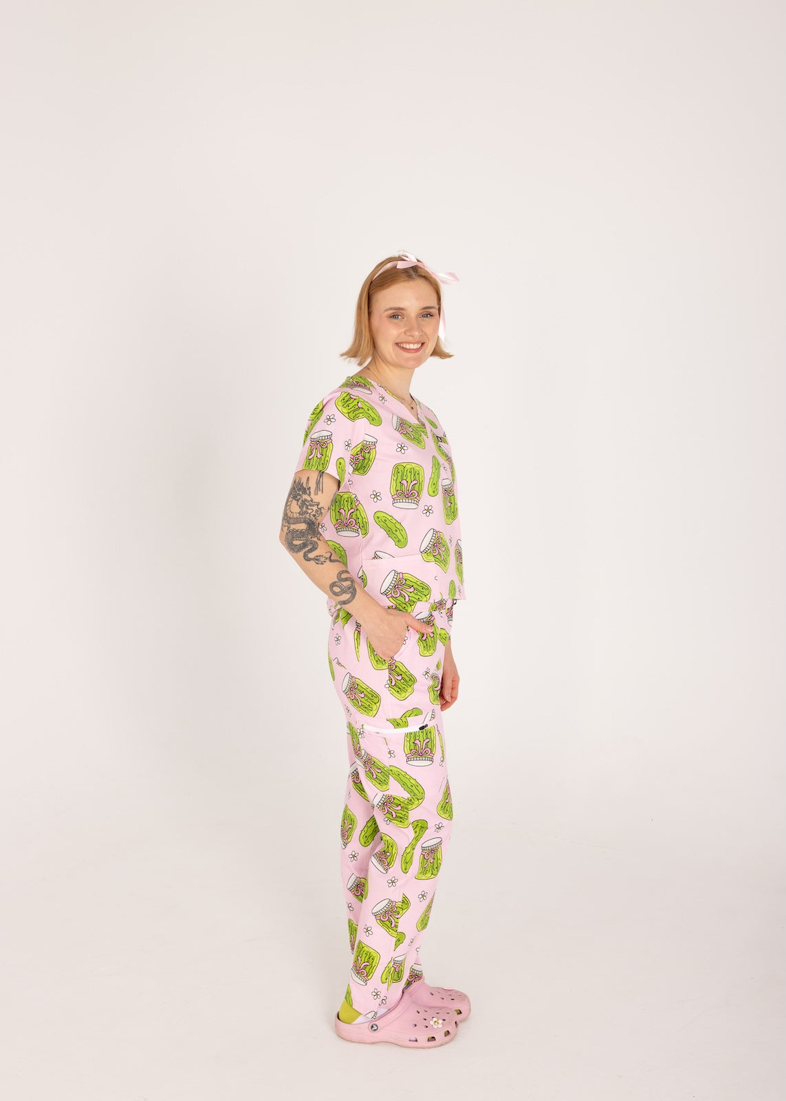 Person wearing pink fun scrubs with pickle pattern