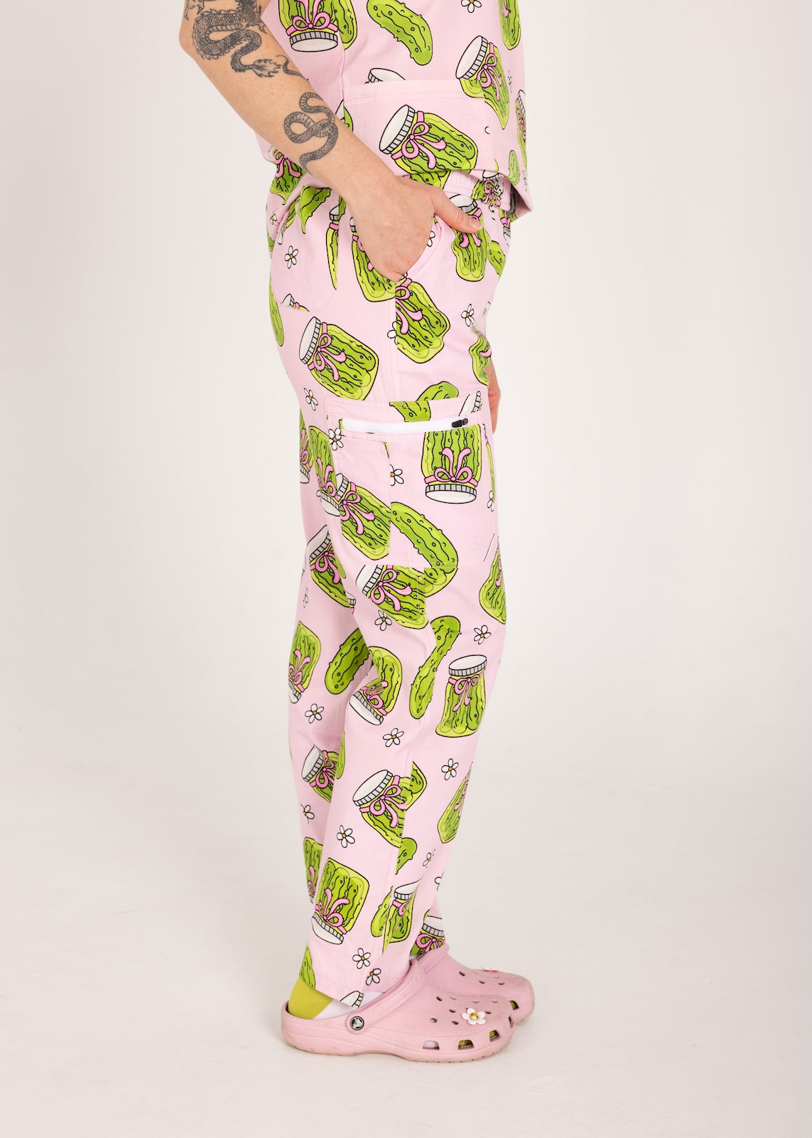 Person wearing pink fun scrubs with pickle pattern