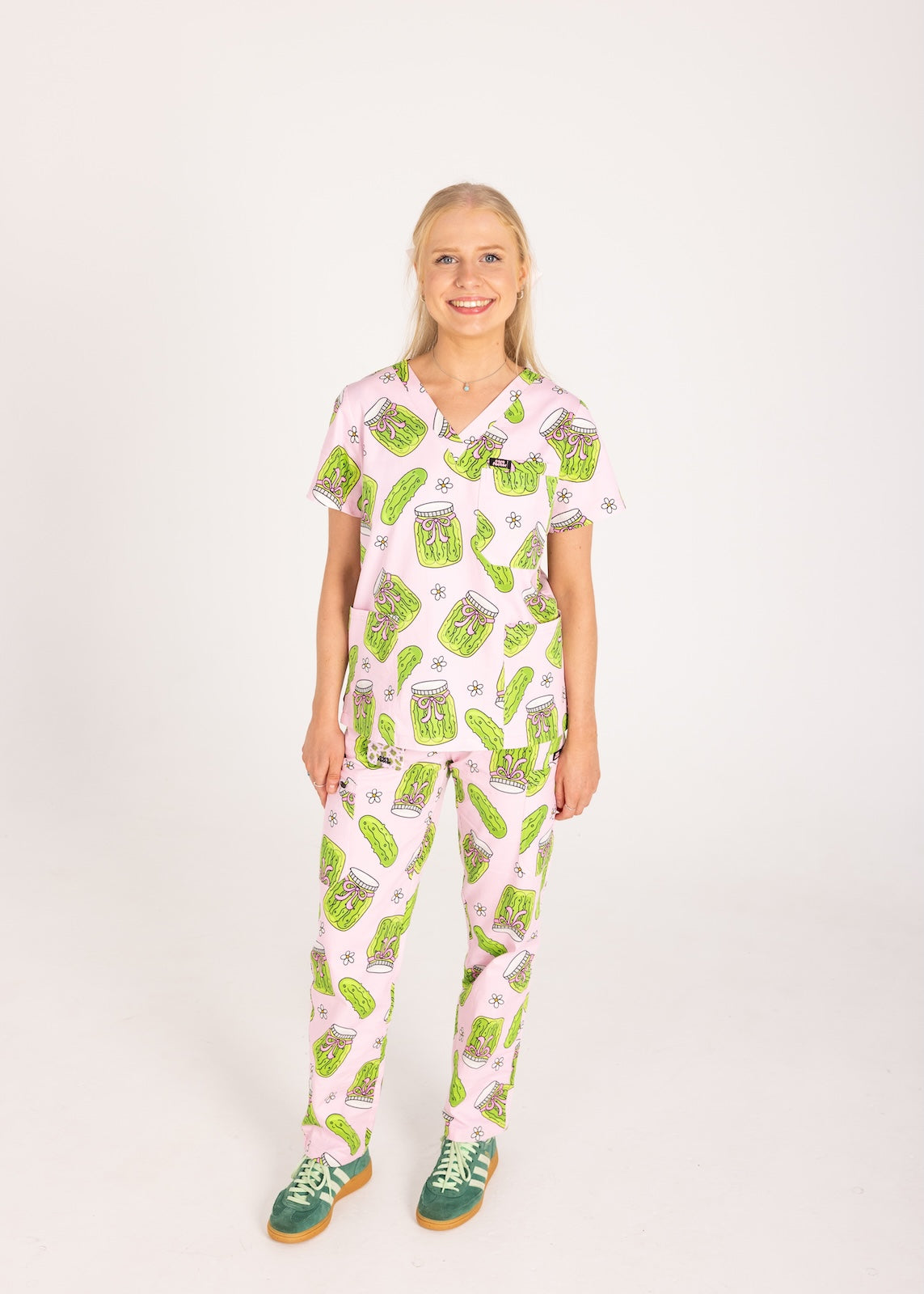 Person wearing pink fun scrubs with pickle pattern