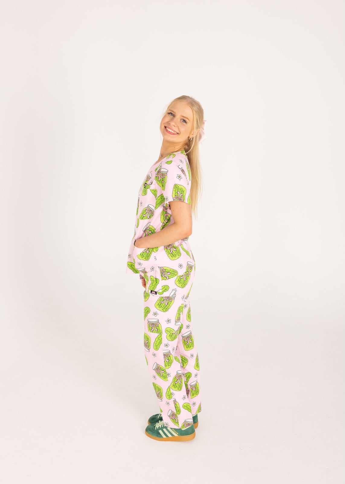Person wearing pink fun scrubs with pickle pattern