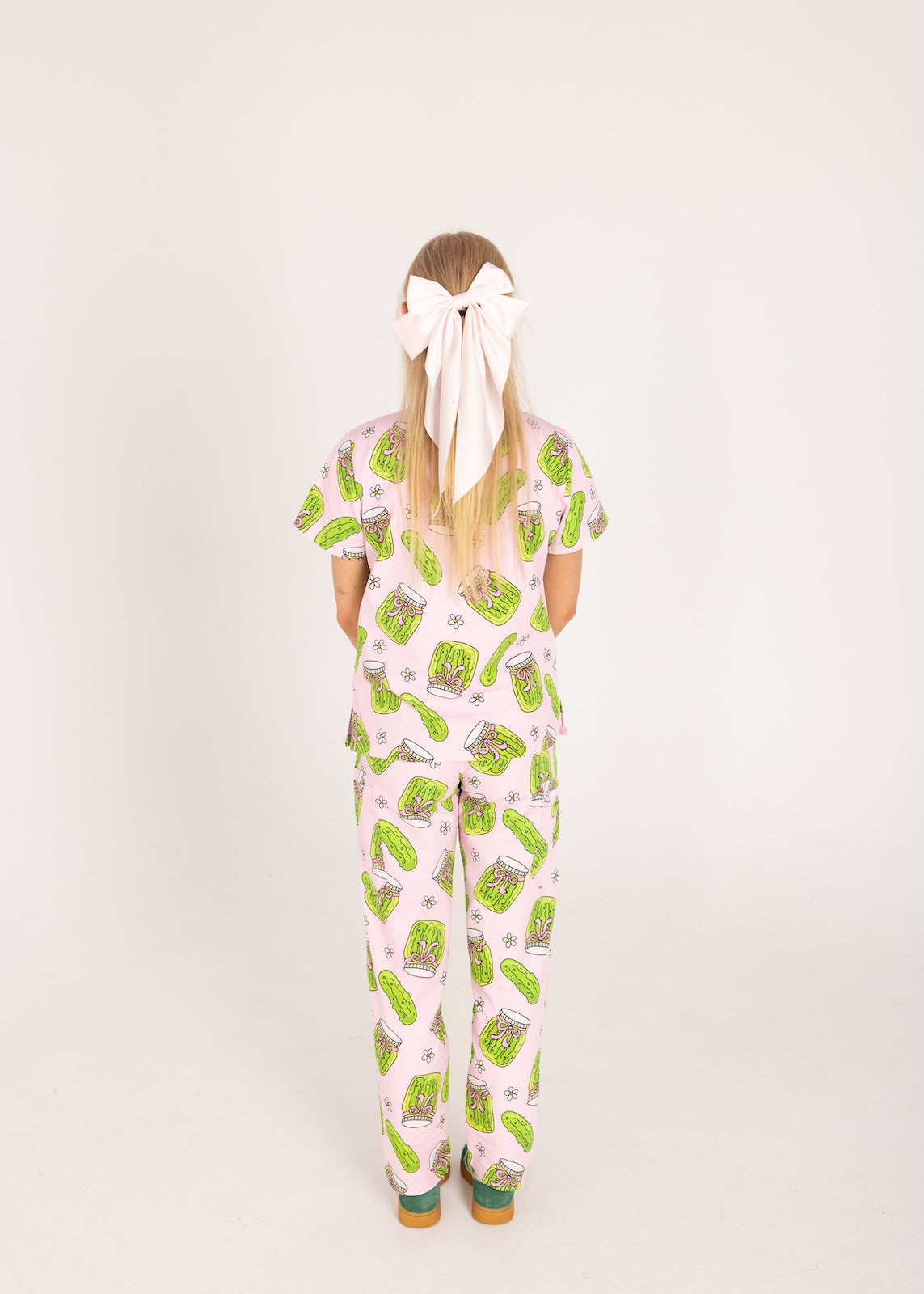 Person wearing pink fun scrubs with pickle pattern