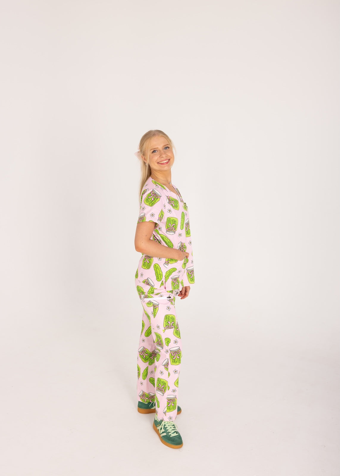 Person wearing pink fun scrubs with pickle pattern