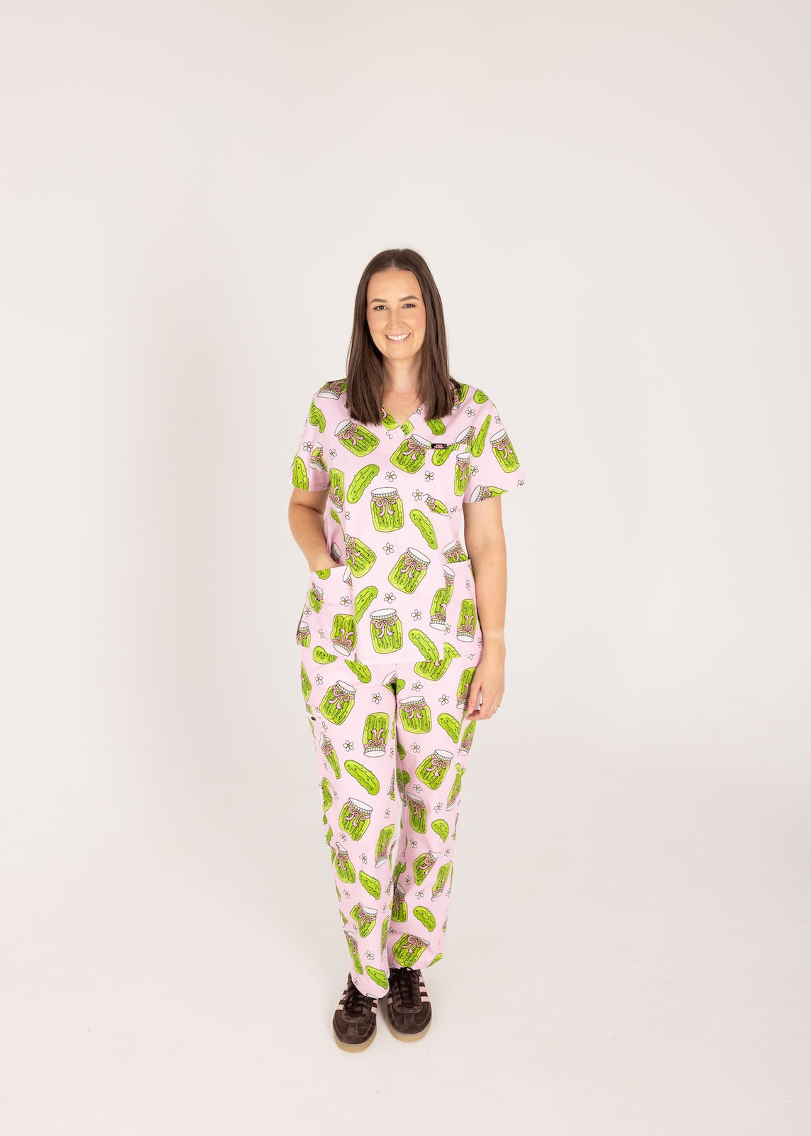 Person wearing pink fun scrubs with pickle pattern