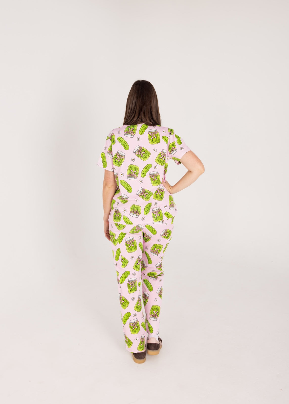 Person wearing pink fun scrubs with pickle pattern