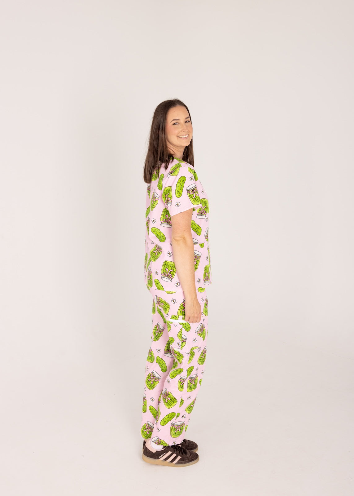 Person wearing pink fun scrubs with pickle pattern