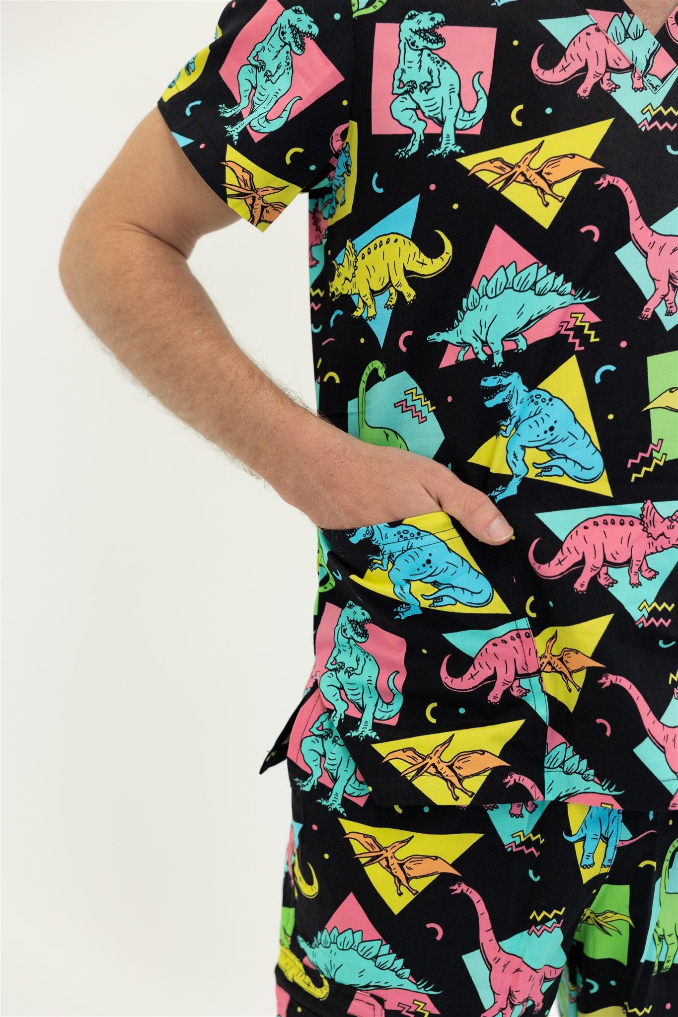 man in black and bright colour retro Dino scrub set top