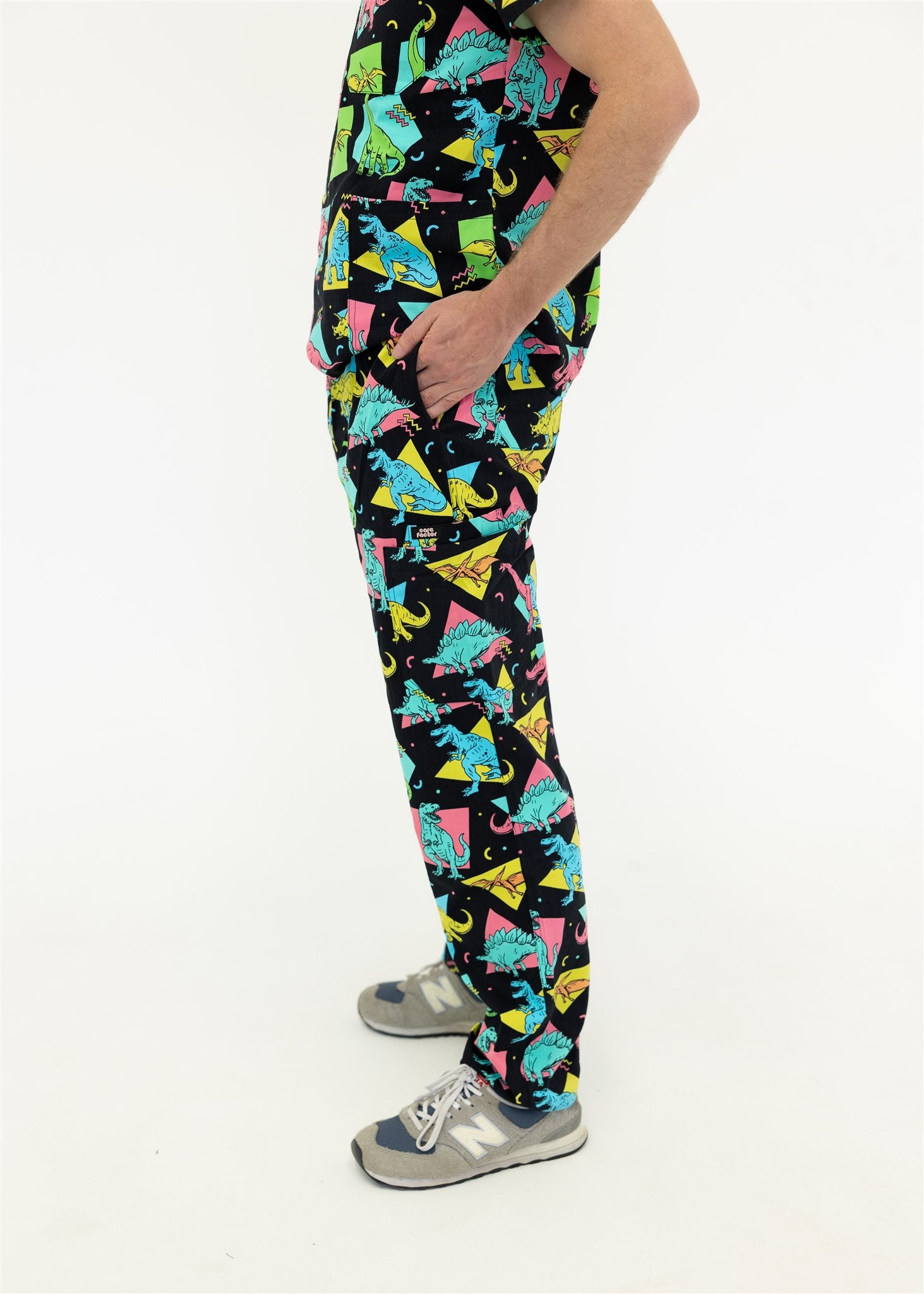 man in black and bright colour retro Dino scrub set pants
