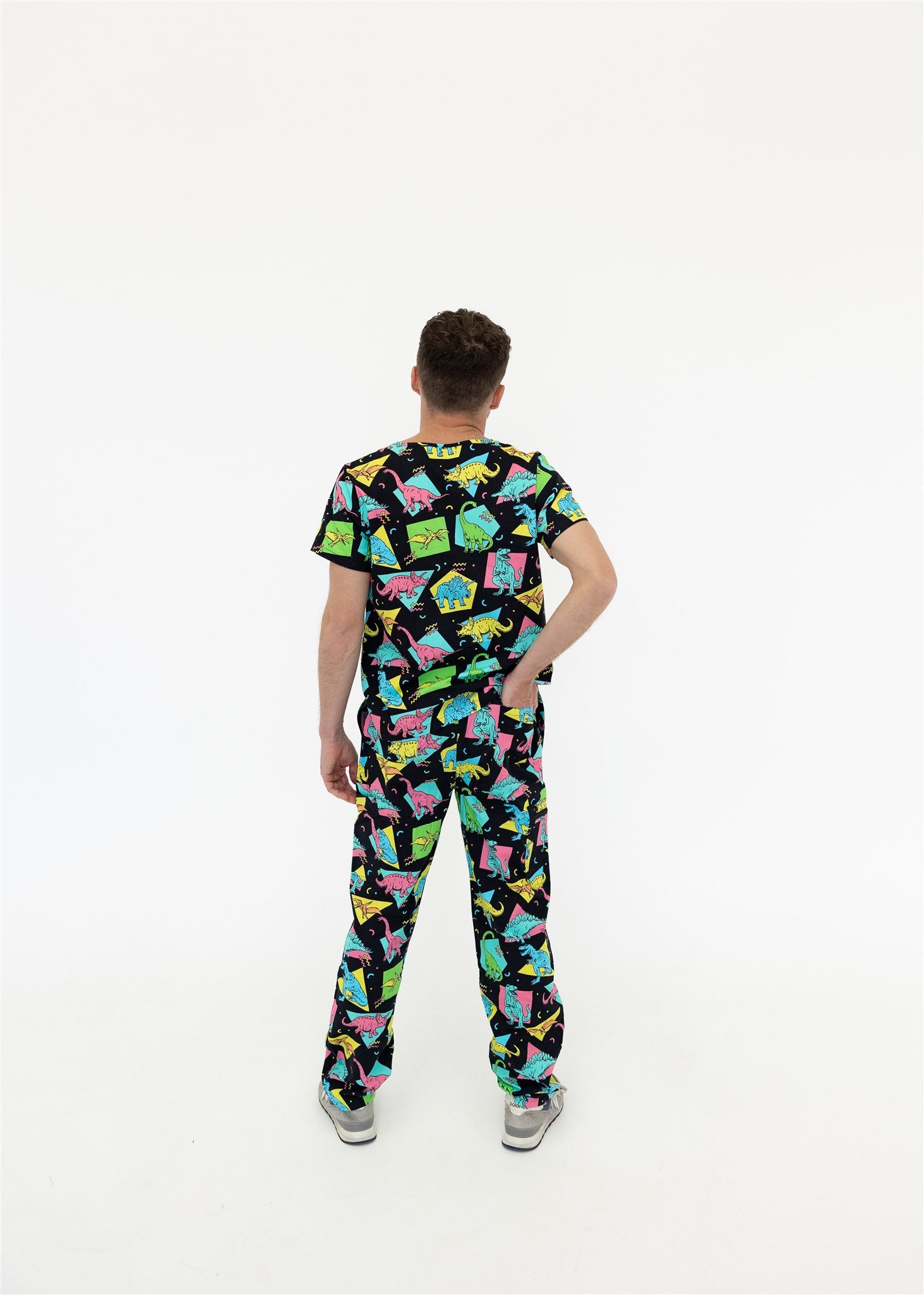man in black and bright colour retro Dino scrub set