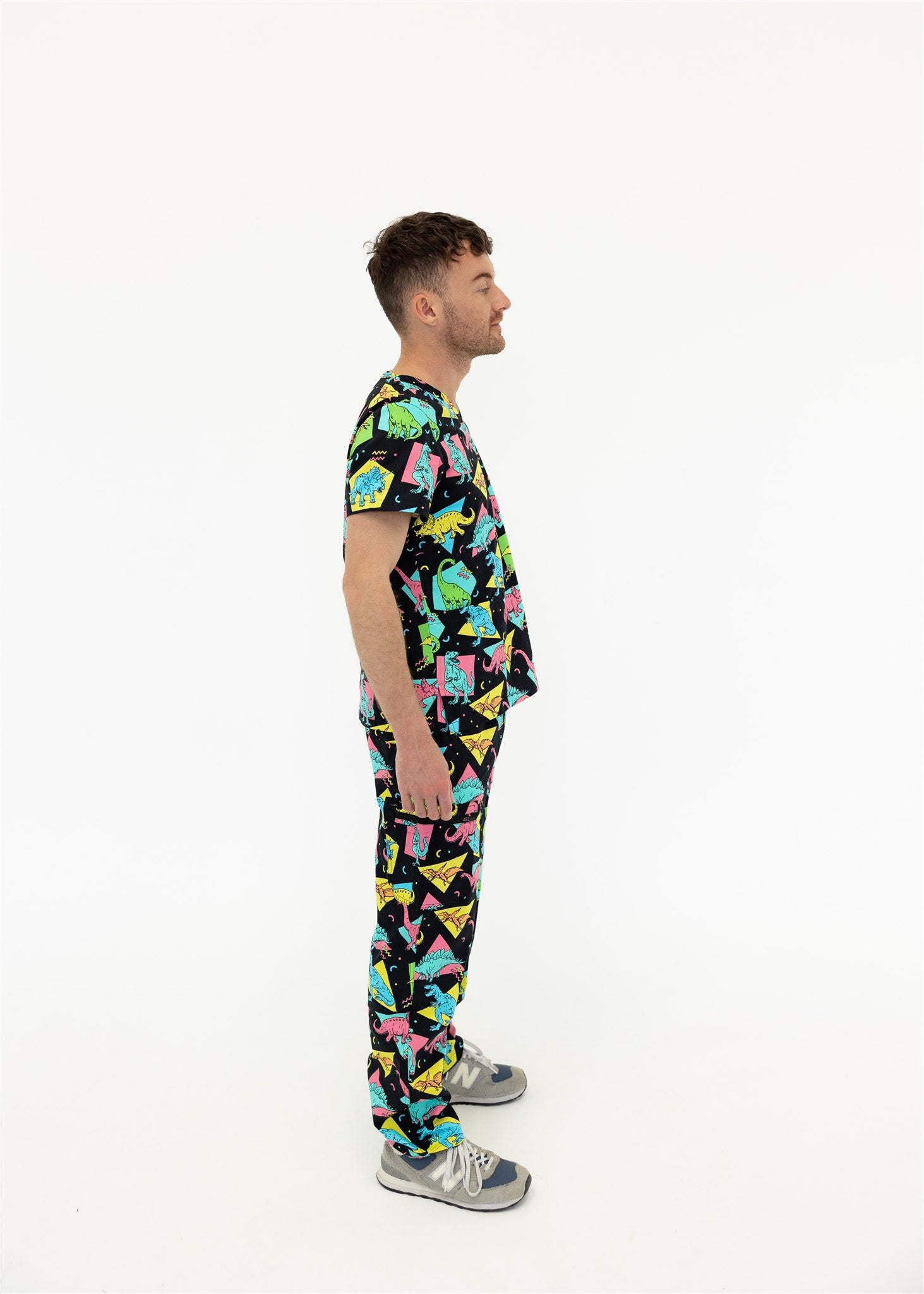 man in black and bright colour retro Dino scrub set