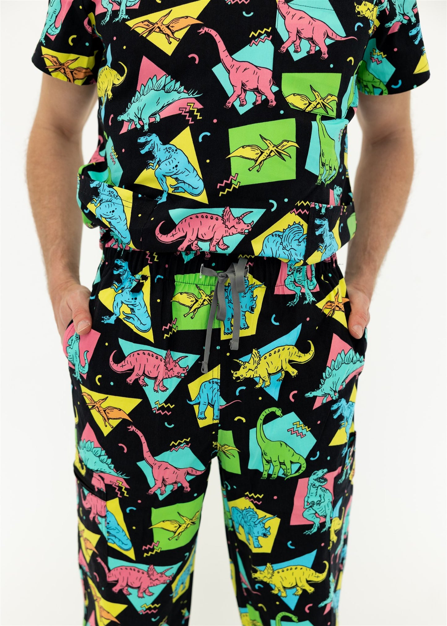 man in black and bright colour retro Dino scrub set 