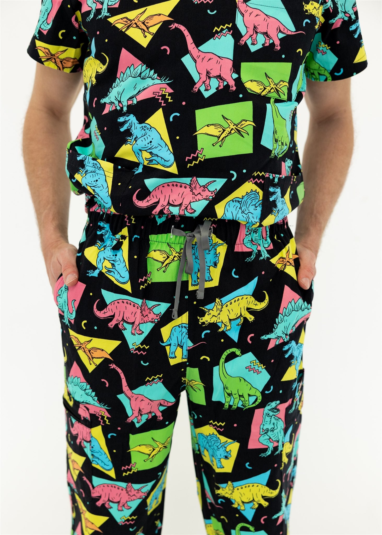 man in black and bright colour retro Dino scrub set 