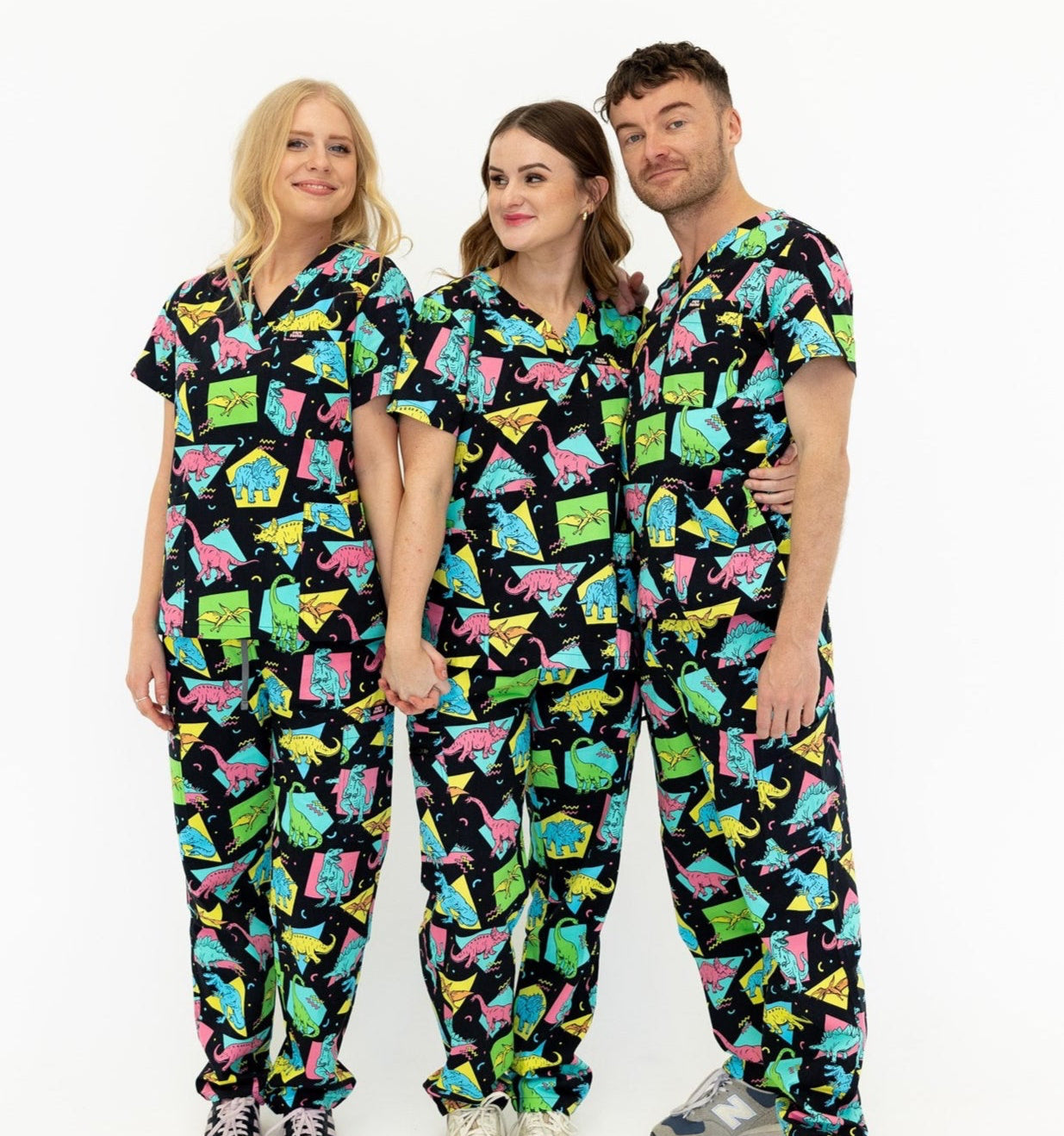 group of nurses wearing black and bright colour retro Dino scrub set