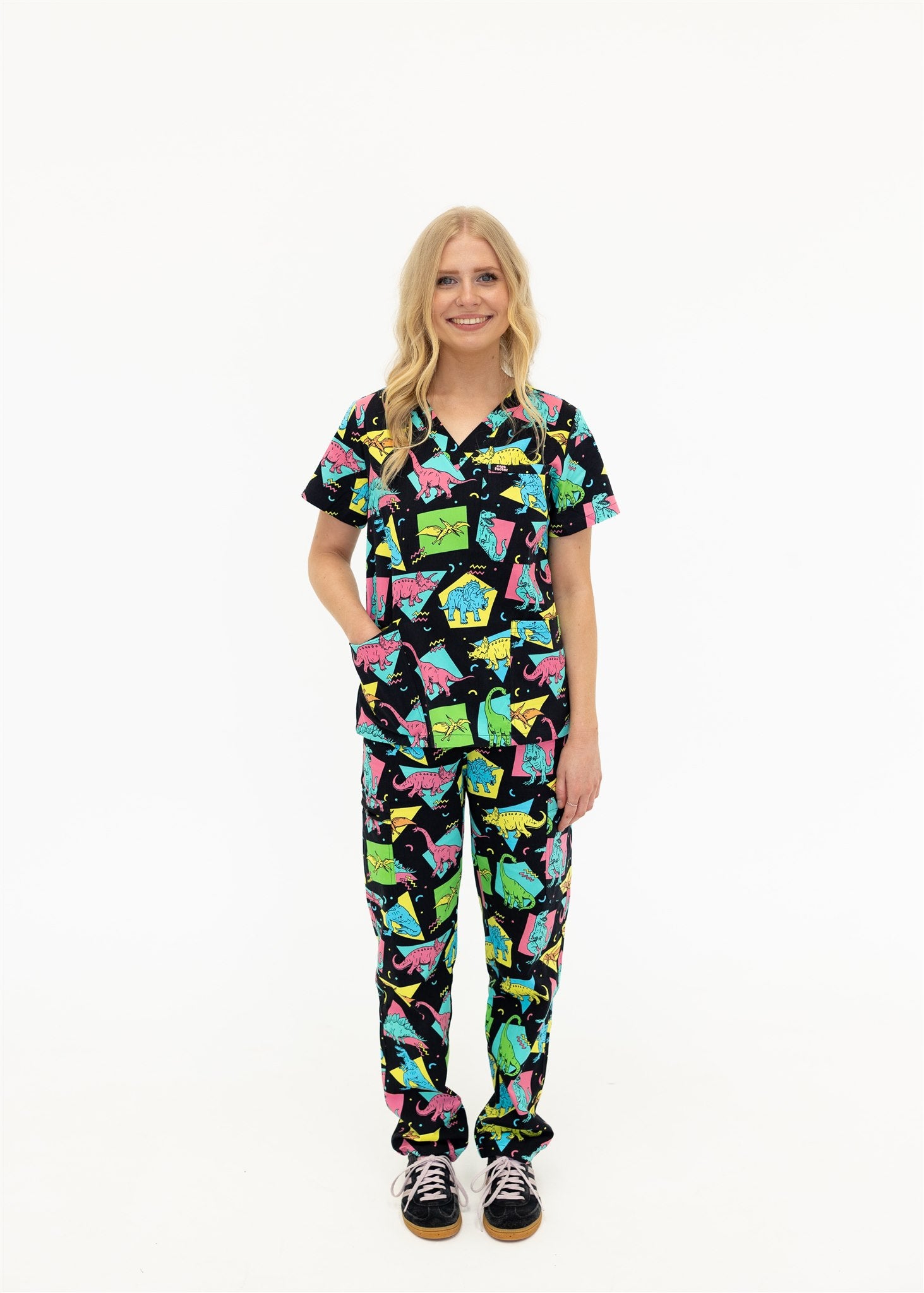 woman in black and bright colour retro Dino scrub set