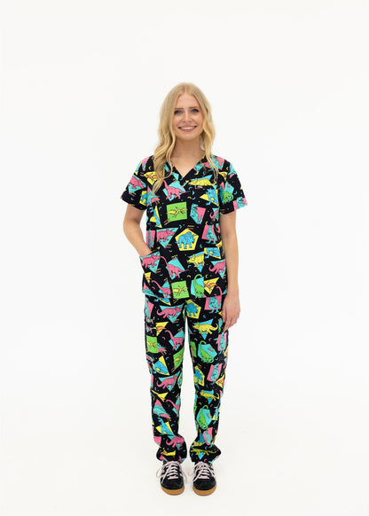 woman in black and bright colour retro Dino scrub set