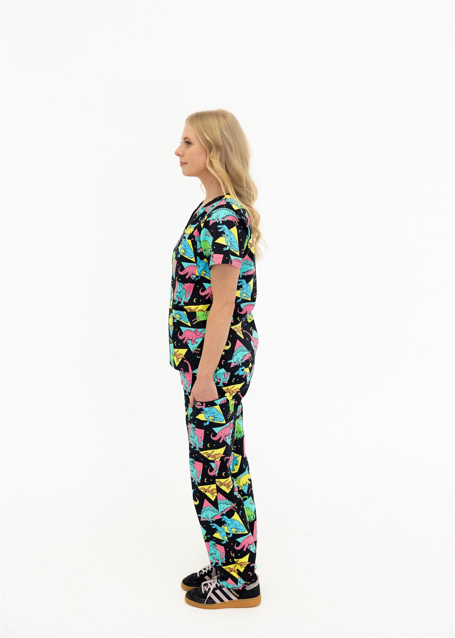 woman in black and bright colour retro Dino scrub set