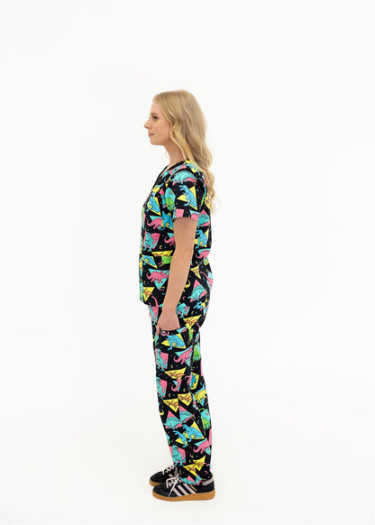 woman in black and bright colour retro Dino scrub set