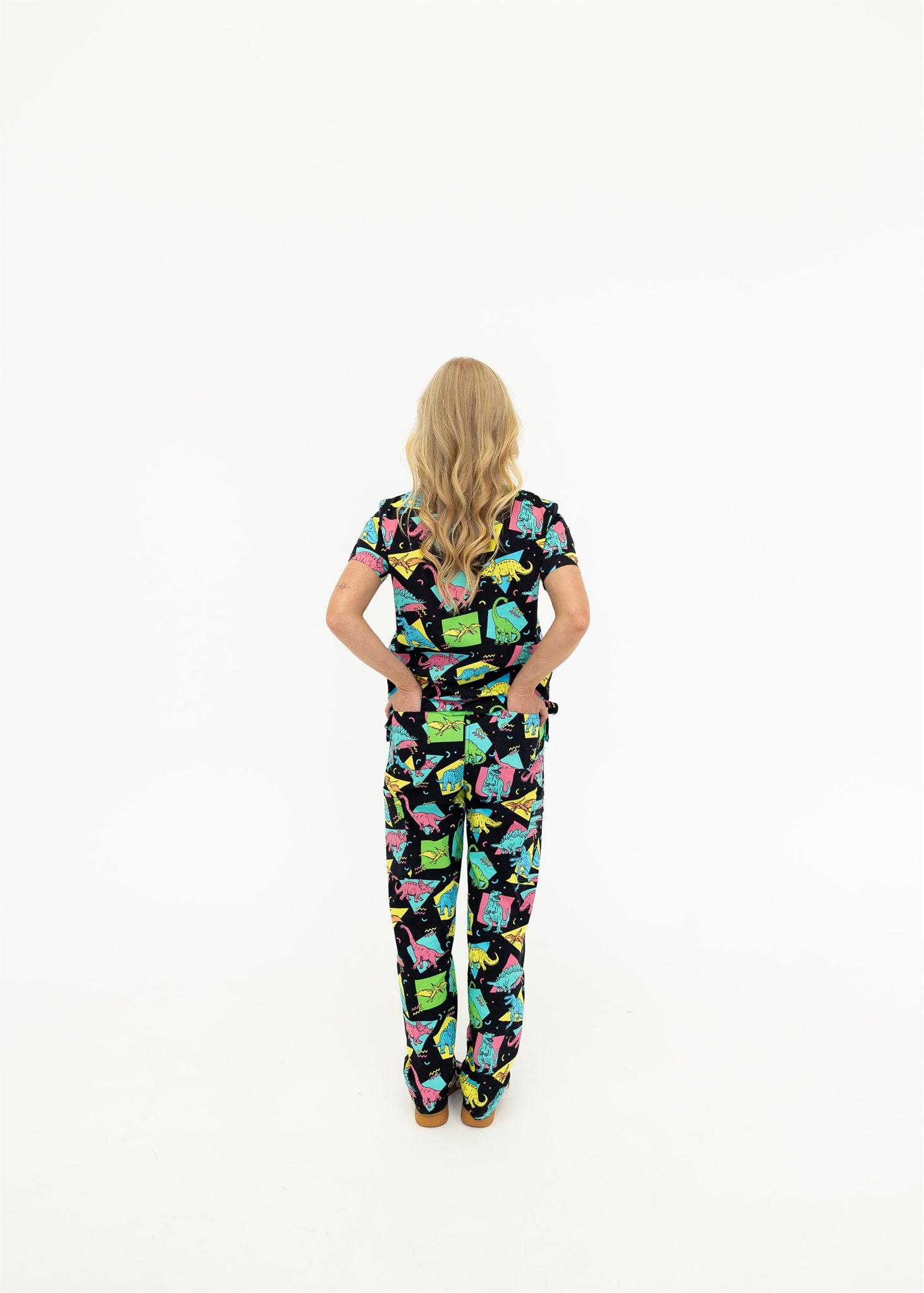 woman in black and bright colour retro Dino scrub set