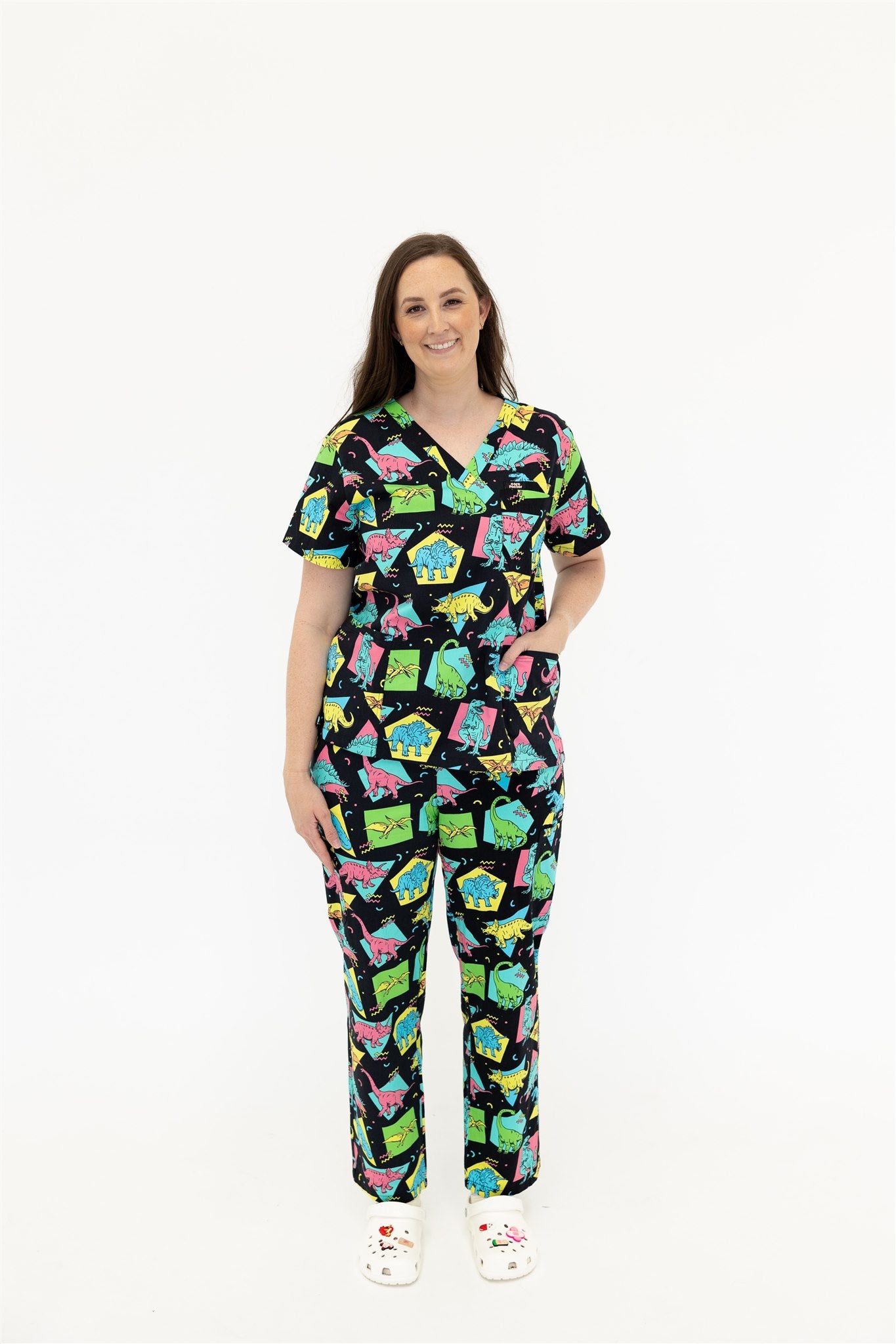 woman in black and bright colour retro Dino scrub set