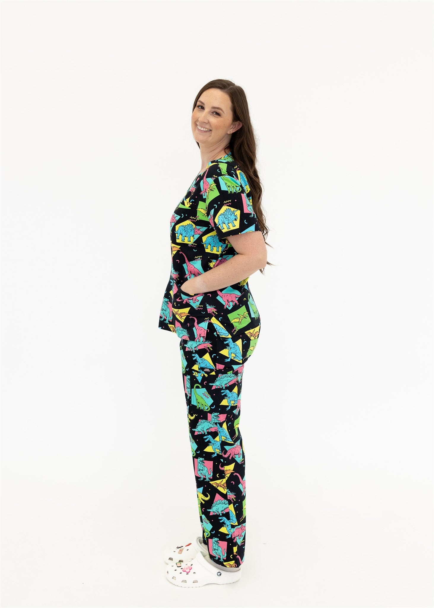 woman in black and bright colour retro Dino scrub set