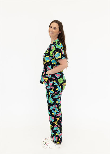 woman in black and bright colour retro Dino scrub set