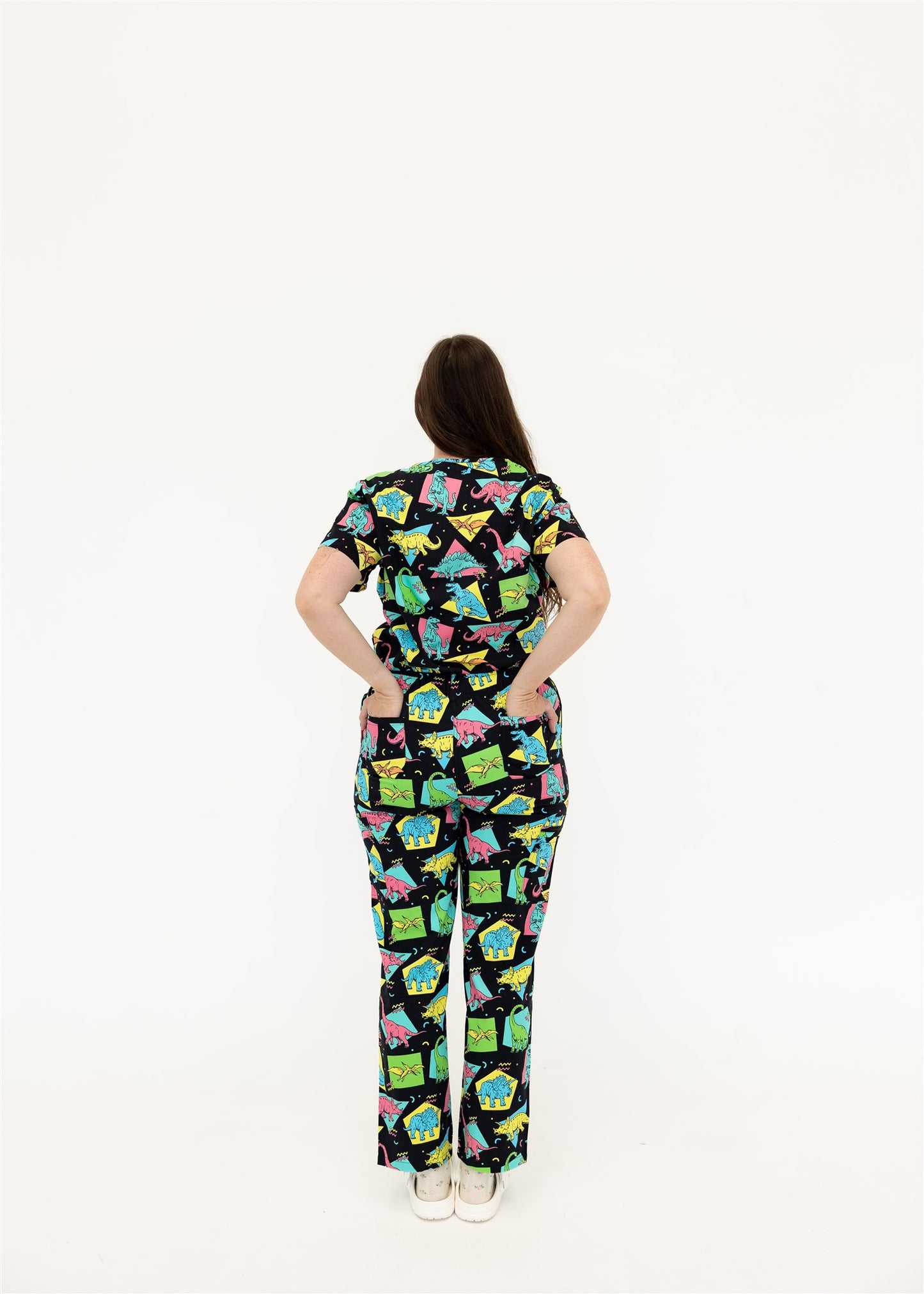woman in black and bright colour retro Dino scrub set