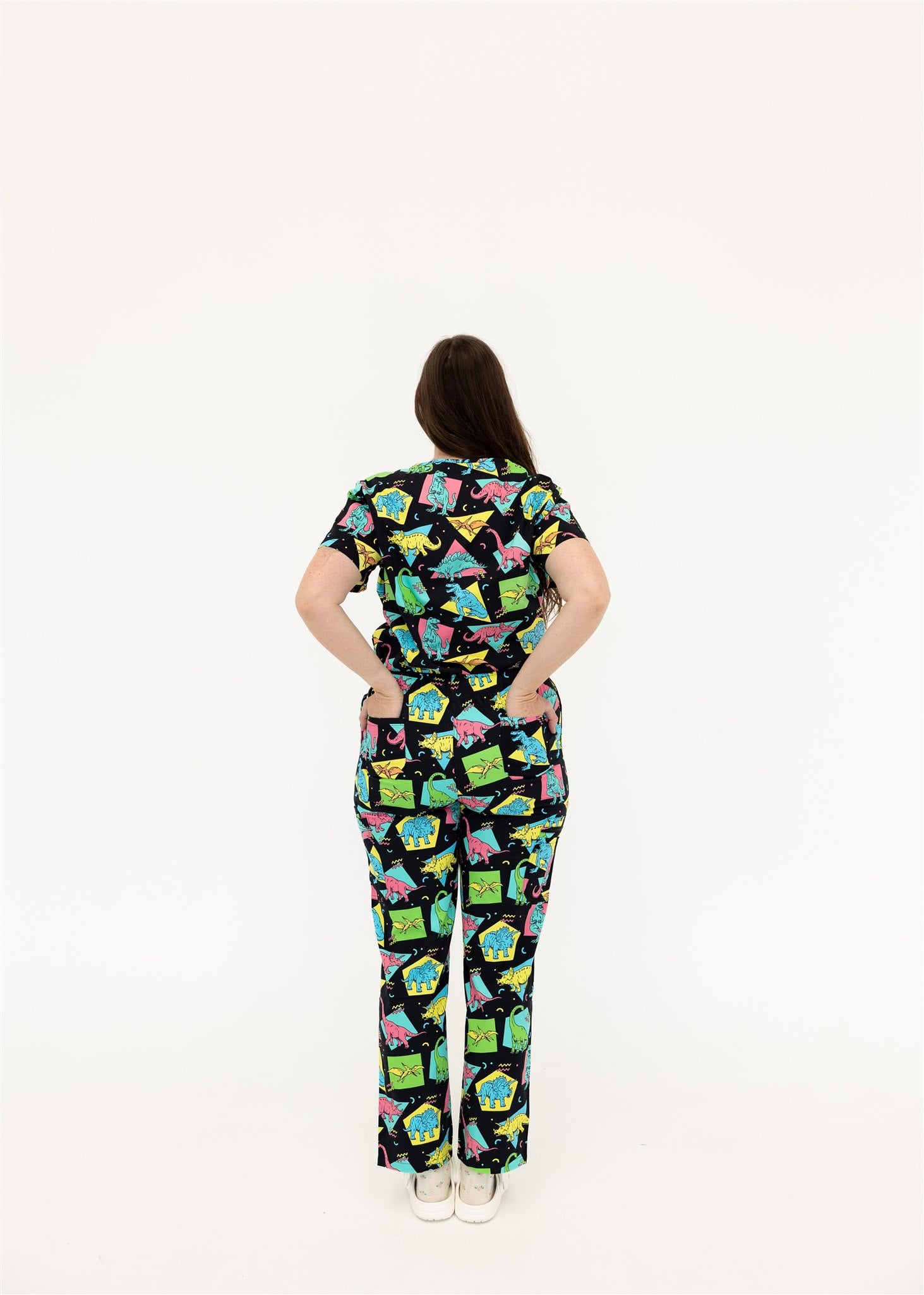 woman in black and bright colour retro Dino scrub set