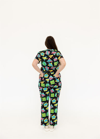 woman in black and bright colour retro Dino scrub set