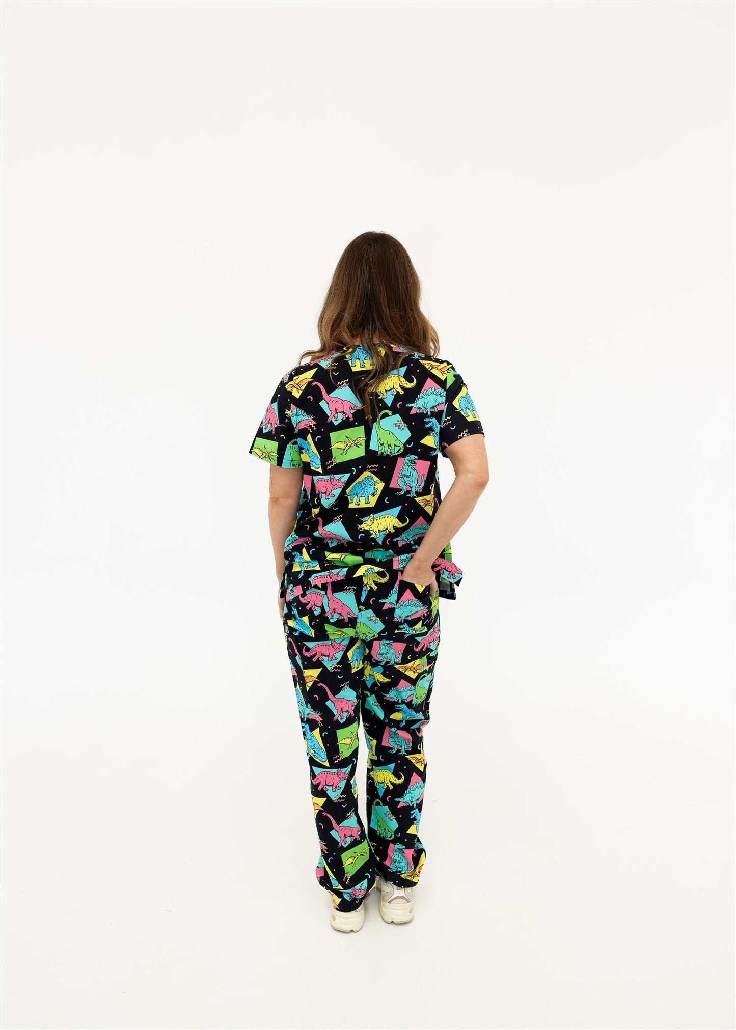 woman in black and bright colour retro Dino scrub set