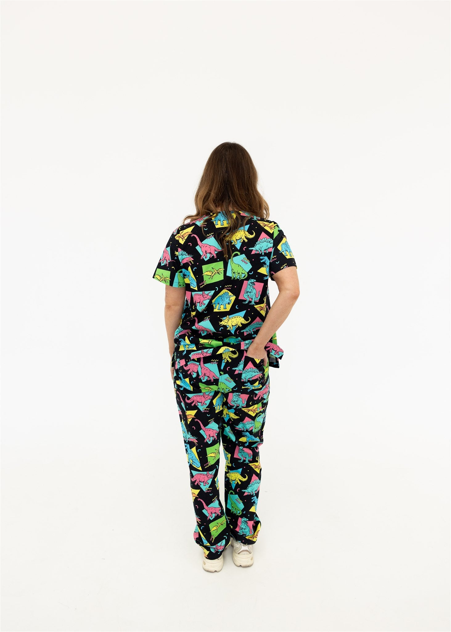 woman in black and bright colour retro Dino scrub set